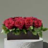 Red roses and foliage in a low wooden box. Standard- 1 dozen