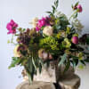 This beautiful arrangement is artfully designed in a birch container filled with