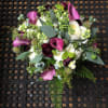 Calla lilies accented with stock and seasonal foliage and berries