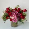 Beautiful one-sided flower arrangement with red mix blooms. Roses and cymbidium orchids