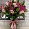 A dozen of pink roses accent with tinted pink solidago, greenery in