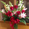 Tall vase of Oriental lilies, red roses and snap dragon are sure