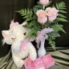 A pink Valentines gift includes pink roses, a soft kitty and a