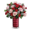 A romantic mix of blush and red roses, perfectly arranged with fresh