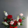 A classic Valentines Day palette of red and pink roses and spray