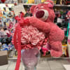 Beautiful vase with eternal roses of ribbon with a beautiful stuffed animal