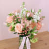 a springy assortment of peach and white florals in a clear 5x8