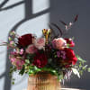 A beautiful mix of pink and red garden roses and carnations in