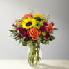 Stunning sunflowers are woven together with other brightly hued blooms to create