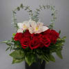 A lavish blend of red roses, and pink orchids blossoms. to express