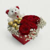 A stunning heart-shaped arrangement featuring velvety red roses, delicate baby&rsquo;s breath, Ferrero