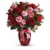 A romantic mix of deep red and soft blush blooms with fresh
