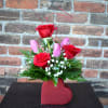 This cute, petite, bouquet designed with red roses, pink tulips, babysbreath, lush