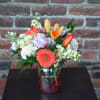 A bouquet bursting with bright colors and soft textures...yellow stock, orange lilies