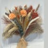 A stunning hand-tied bouquet featuring pampas grass, dried florals, and earthy autumn