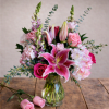 This elegant vase is filled with a beautiful arrangement of pink and
