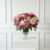 A large elegant arrangement of roses and ranunculus in shades of pink.