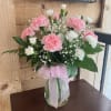 Soft pink and white Carnations make a sweet arrangement.