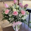 This bouquet has pink and white roses, pink carnations and baby's breath
