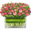A mixed-color tulip arrangement in a vase is a vibrant and elegant