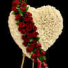 A breathtaking heart-shaped sympathy arrangement crafted with pristine ivory roses, symbolizing peace