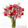 A luxurious and decadent design of roses, lilies, and snapdragons that will