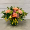 This arrangement features a spring mix of roses, carnations, tulips, filler flowers