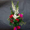 A bold mix of red roses, vibrant gerbera, and creamy white lilies