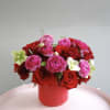 A bold and romantic arrangement featuring lush red roses paired with vibrant