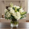 Like fresh snow on a quiet morning, this arrangement is a peaceful