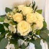 White roses and greens, with Peruvian lilies and babies breath. Truly elegant