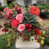 A vibrant and lively arrangement with bold pinks, reds, and corals, balanced