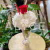 A hydrangea and rose in a soda glass, a floral replica of