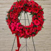 This elegant arrangement of deep red blooms, symbolize respect, love, and remembrance