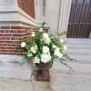 An all white lovely flower arrangement, perfect for a sympathy occasion.