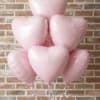 Half dozen pink heart shaped mylar balloons.