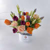 Lovely local Oregon tulips arranged in a classic white ceramic vase and