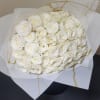 White roses carefully wrapped in white delicate paper bringing to life a