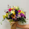 This hand-tied bouquet combines 30 stems of bright and cheerful blooms and