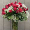 36 long stemmed red roses arranged in a vase with baby's breath