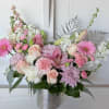 Beautiful blush, lavender, and white blooms, in a one sided arrangement. Approximately