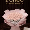 This refined hand-tied bouquet features premium blush pink roses, elegantly wrapped in