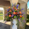 This glorious garden urn has blue delphinium, free spirit roses, lavender stock