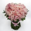An arrangement of pink roses with a soft orchid accents, finished with
