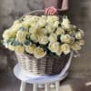 basket of white roses with eucalyptus