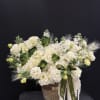 Luxurious white hydrangeas, carnations, lisianthus, stock flowers, fresh greenery, and cascading textures