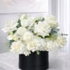 Elegant white flower box with fresh roses, hydrangeas, ranunculus, calla lilies, and
