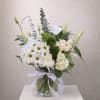 Beautiful White and green arrangement in a glass vase 