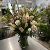 An amazing design featuring lilies, roses, stock, lisianthus, snapdragons, bells of Ireland