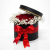 A timeless and romantic arrangement featuring lush red roses nestled beneath a